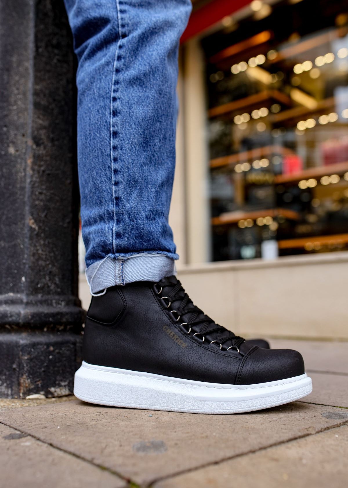Men's Kelly Midnight Majesty by Apollo Moda, black vegan leather high-top boot worn with jeans